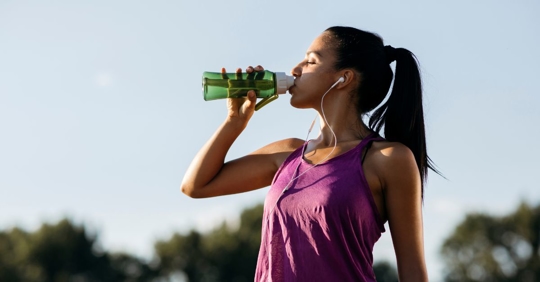 woman running and drinking water
